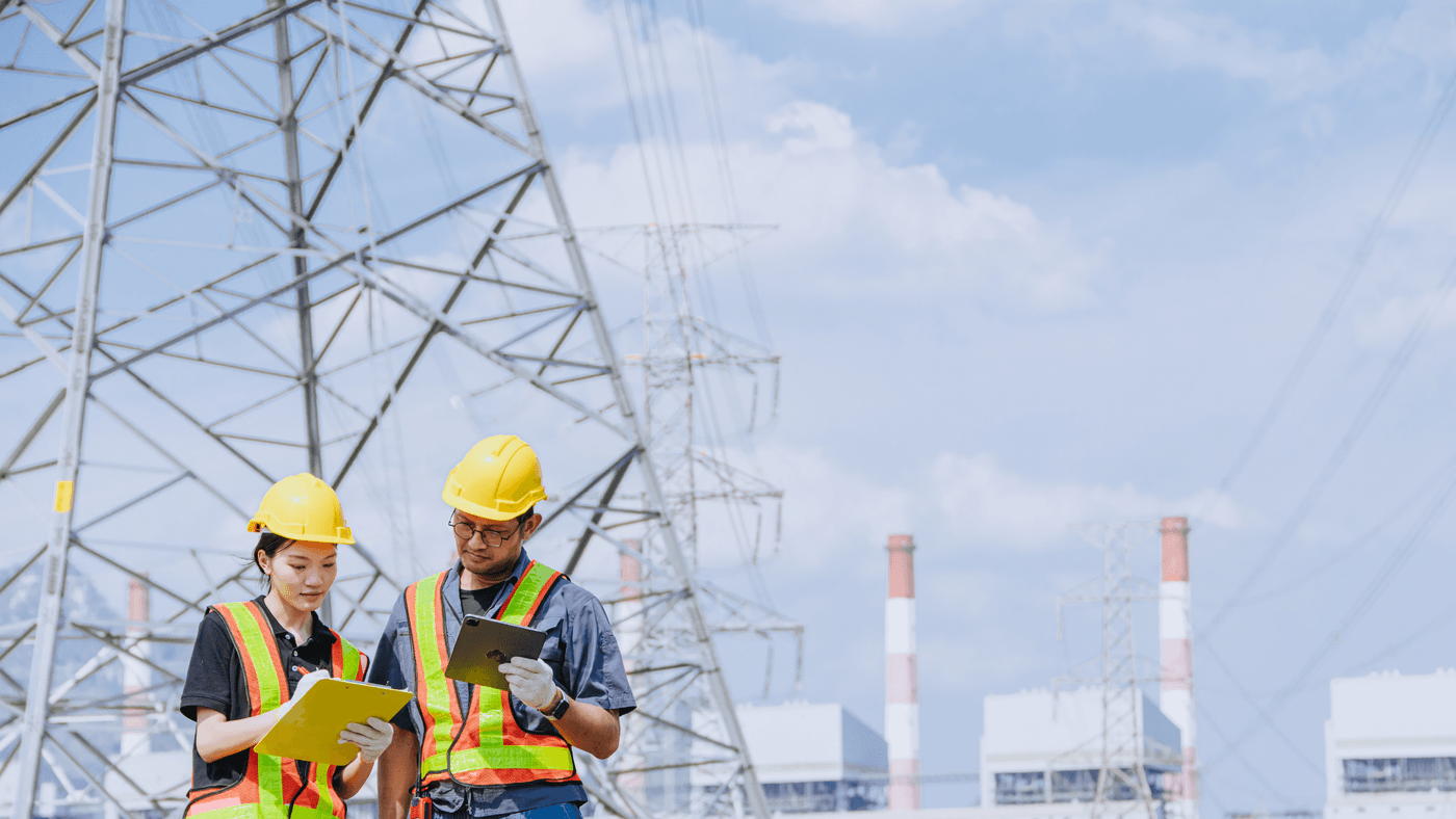 送電鉄塔と点検作業員。既設の系統設備につながる送電網